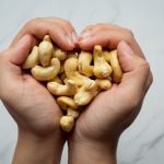 Raw cashews nuts on marble background